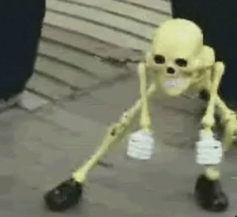 A toy skeleton dancing on the sidewalk.